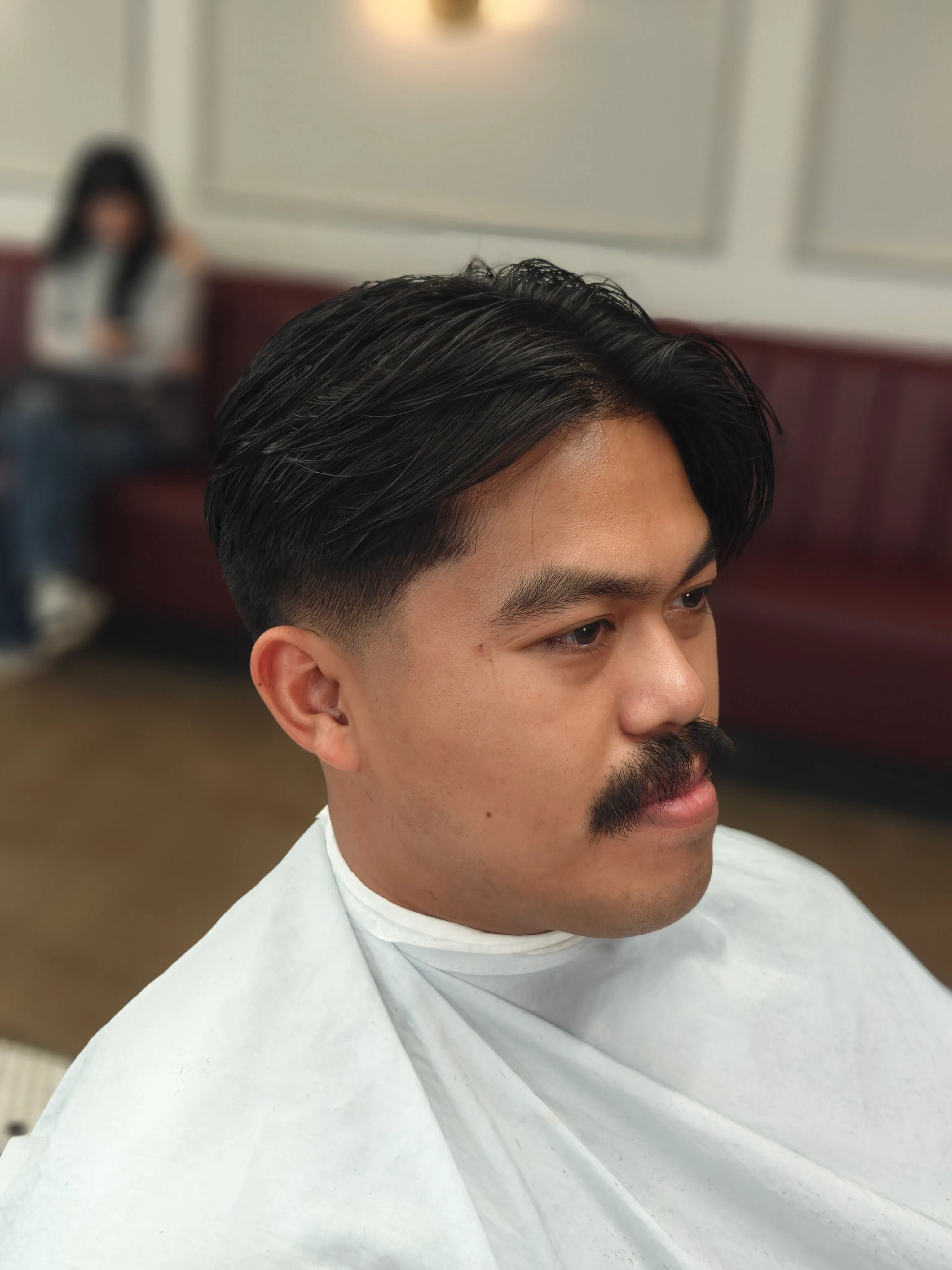 Man receiving a professional haircut at Richmond Barbershop in Richmond VA