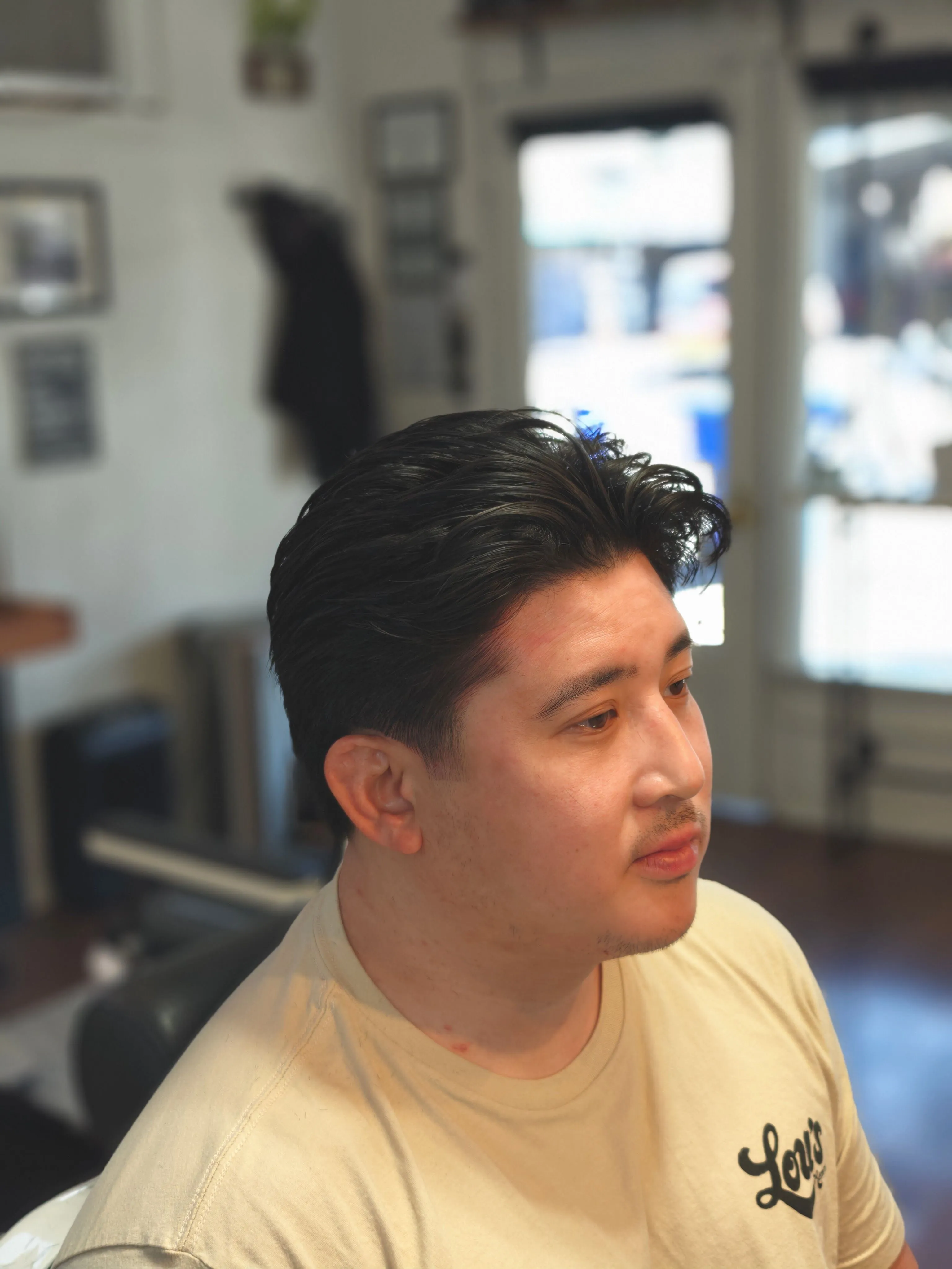 Skilled barber performing a haircut at Richmond VA barbershop